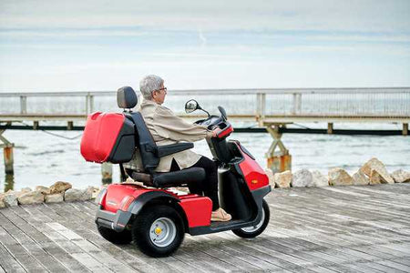 woman on Red Afiscooter S3 3-Wheel Electric Scooter By Afikim | Wheelchair Liberty