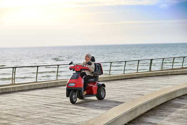 woman on Red Afiscooter S3 3-Wheel Electric Scooter By Afikim | Wheelchair Liberty