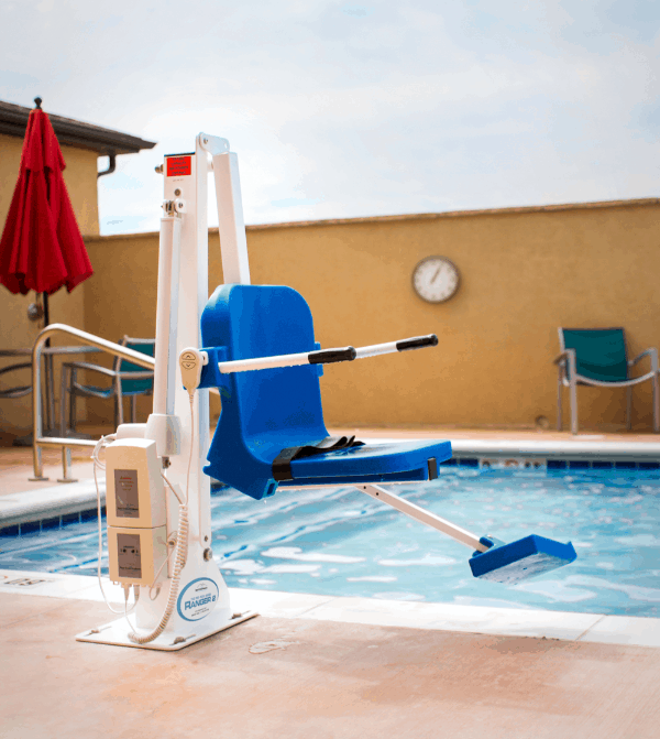 White Aqua Creek Ranger 2 pool lift with blue seat beside an outdoor pool