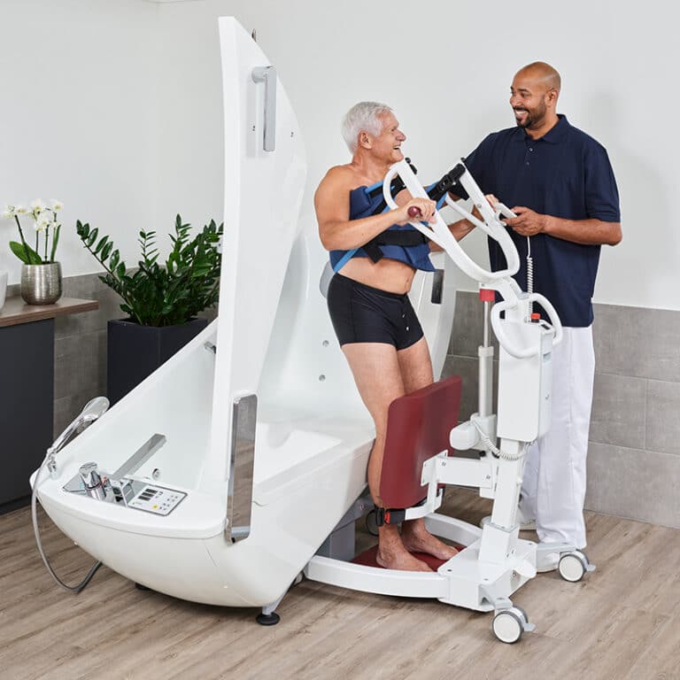 caregiver helping man out of bathtub with sit to stand lift