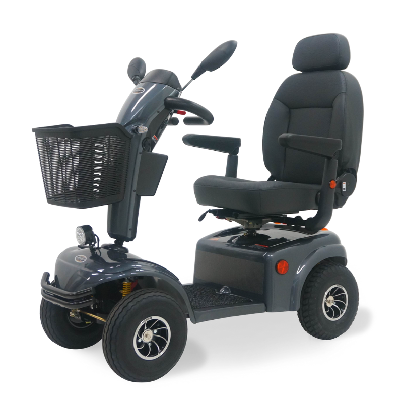 Gray Expedition XL4 4-wheel mobility scooter with a high-back captain’s seat, front basket, rearview mirrors, headlight, and all-terrain tires, shown on a white background.