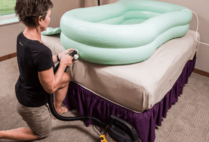 Woman inflating EZ-BATHE® Body Washing Basin By EZ-ACCESS | Wheelchair Liberty