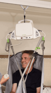 Lifting patient using Savaria Portable Patient Lift Motor by EZ-ACCESS | Wheelchair Liberty