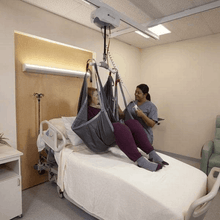 Side View Caregiver Use - C-1000 Bariatric Ceiling Lift By Handicare | Wheelchair Liberty