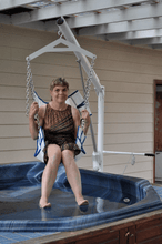 Woman above a jacuzzi using Super Power EZ Above-Ground Pool lift by Aqua Creek | Wheelchair Liberty