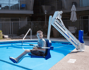 Young Boy Being Lowered into the Pool Using Mighty 400 Powered Pool Lift ADA Compliant by Aqua Creek | Wheelchair Liberty